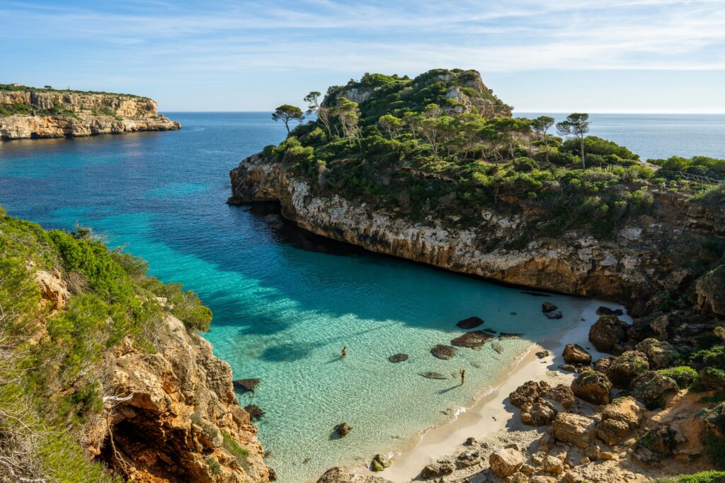 Secluded turquoise cove beach in Mallorca for a luxury couple itinerary.